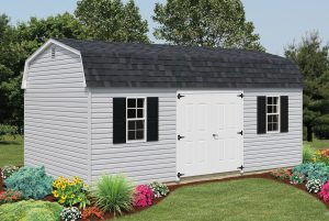 Dutch Barn style shed with light gray vinyl siding, white double doors, 2 windows with black shutters, and black roofing.