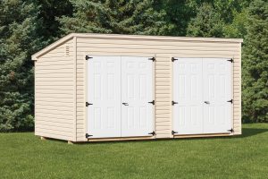 Lean-to shed with beige vinyl siding and 2 sets of white double doors.