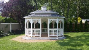 Oval white vinyl double roof gazebo with gray roofing and a white cupola.