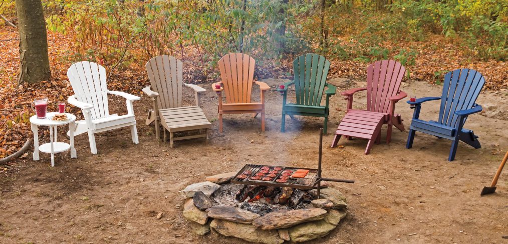 poly wood chairs around a backyard campfire
