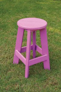 Purple poly furniture barstool sitting in grass.