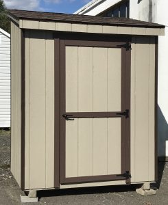 lean-to shed with tan siding and brown trim