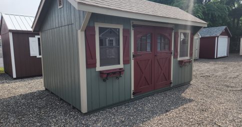 Stock# 10-23  10 x 16 Quaker , painted Avocado, w/ Archlite doors, Golden Gdn pkg & flower boxes, $6923.00. Sale $6576.00