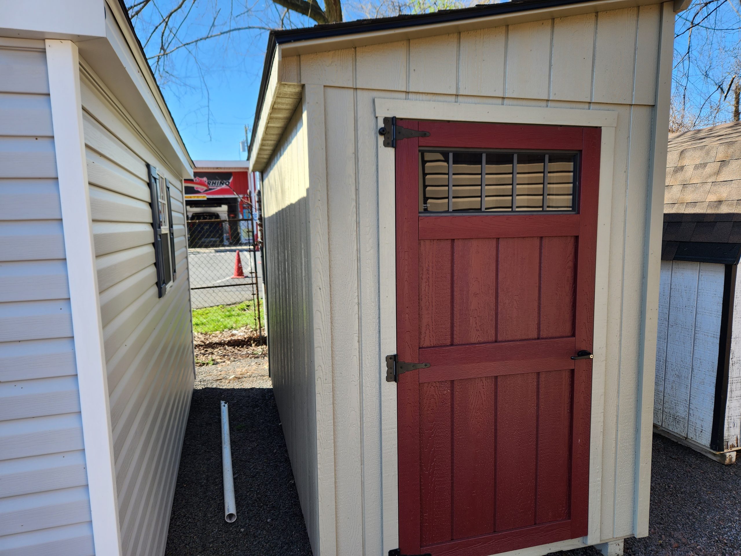 Stock# 20-23  5 ×10 Lean to shed, red door, work bench, low72" high 84", 3106.00