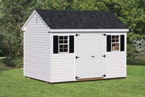 A-Frame & Cape Style Shed with white vinyl siding, 2 windows with black shutters, white double doors, and a black roof.