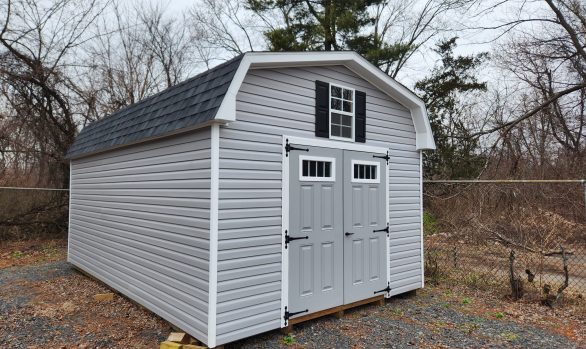 Stock#45-22 12×20 Vinyl DB 7' walls, painted doors w transom glass, lofts all sides, work bench,  8" overhang,  rll roof vents, Discounted $8005.00