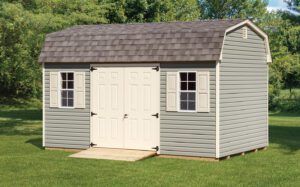 tan dutch barn shed with cream doors and window shutters and a ramp