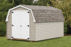 mini barn shed with tan siding, tan roof, and white double doors