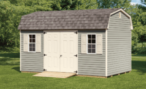 dutch barn shed with green siding and a ramp