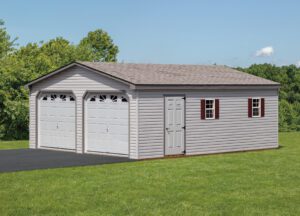 double wide garage with white siding and red window shutters